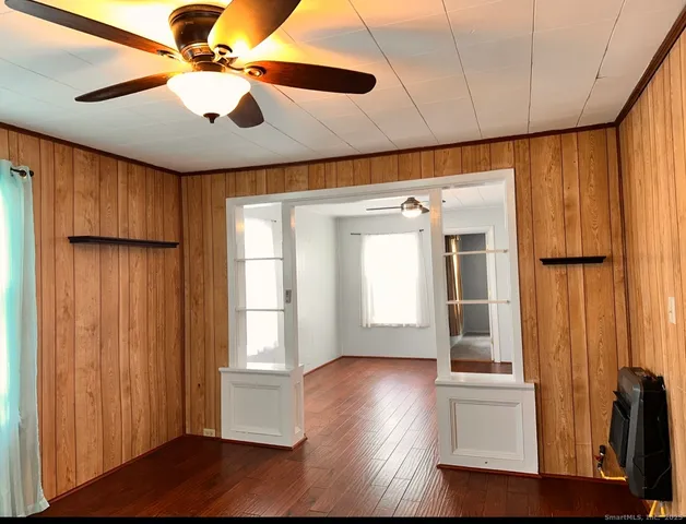 a view of empty room with wooden floor