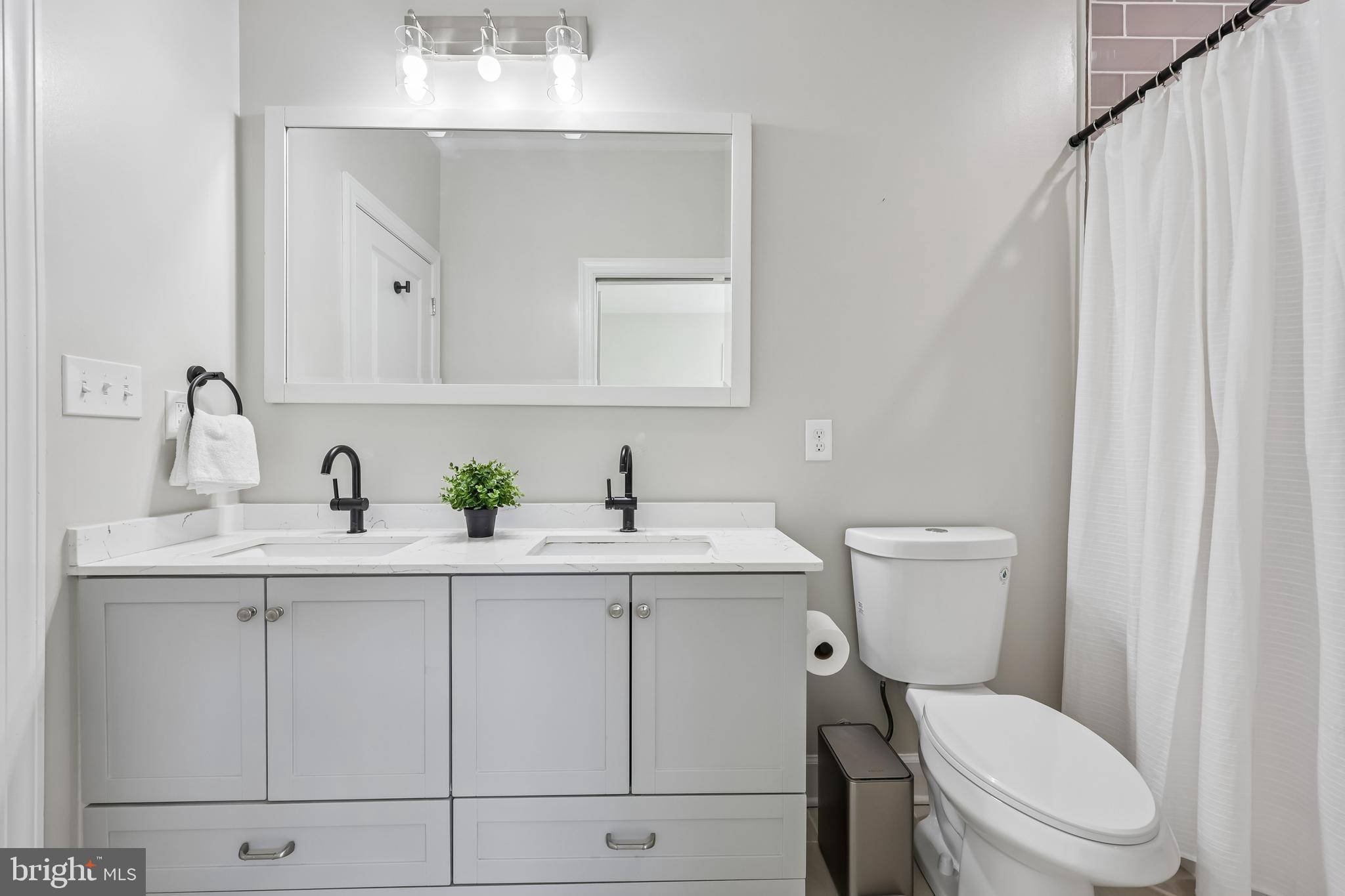 12304 Popes Head Road Fairfax, VA 22030 - Photo 39 of 78 a bathroom with a toilet sink and mirror