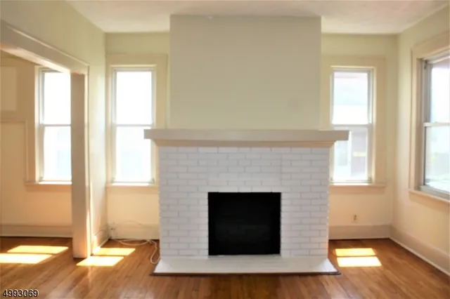 a living room with a fireplace and a floor to ceiling window
