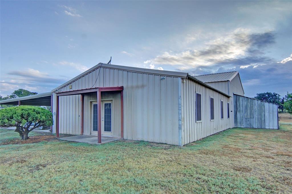 272 Edward Farris Road Weatherford, TX 76085 - Photo 36 of 40 Metal-clad structure with a covered entry, a metal roof, and an attached carport