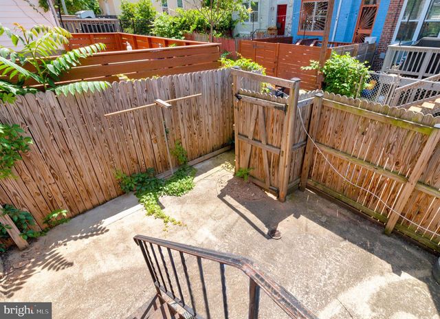 a view of a street with wooden fence