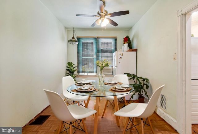 a dining room with furniture a rug and wooden floor