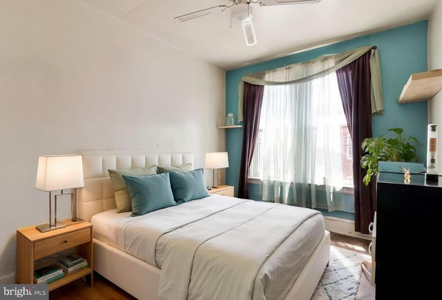 a bedroom with a bed and a window