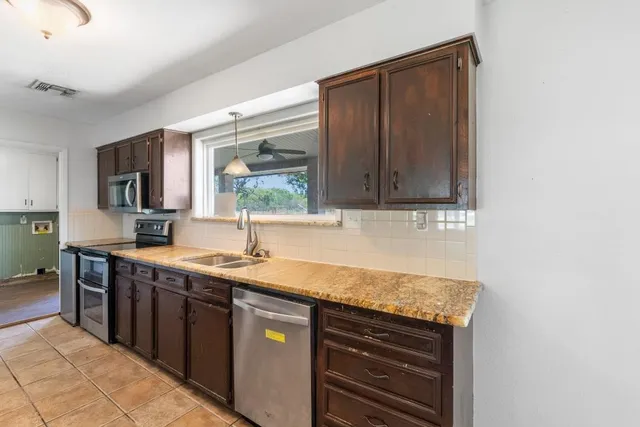 a kitchen with a sink and a stove