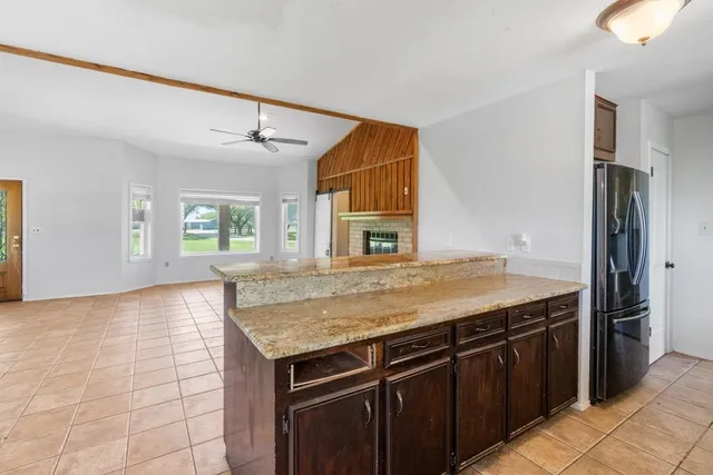 a kitchen with a stove a sink and a refrigerator