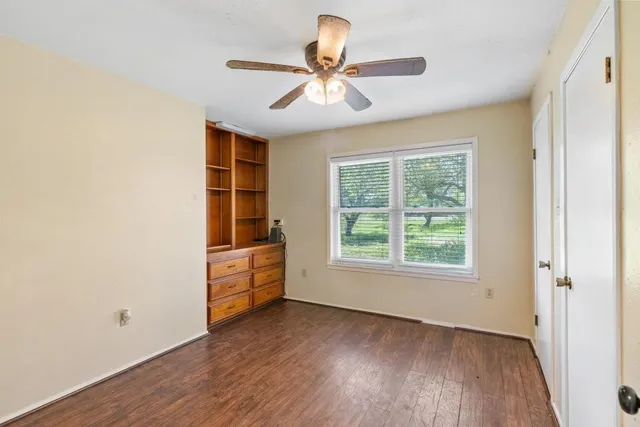 a bathroom with a granite countertop toilet a sink and shower