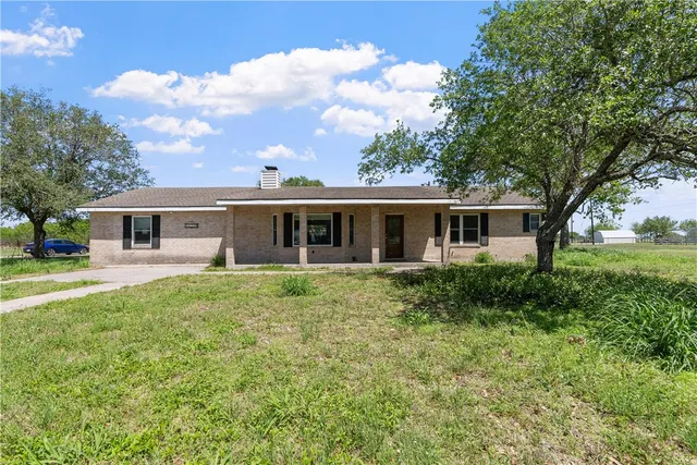 a front view of house with yard and green space