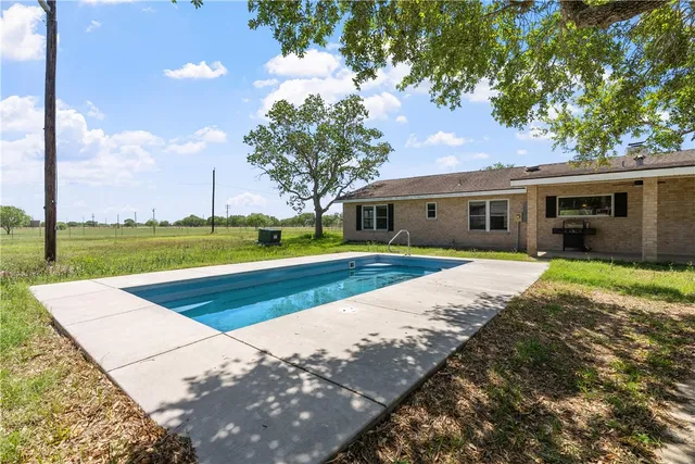 a view of house with yard and green space