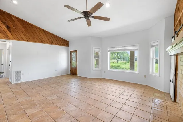 a view of a livingroom with a ceiling fan and window
