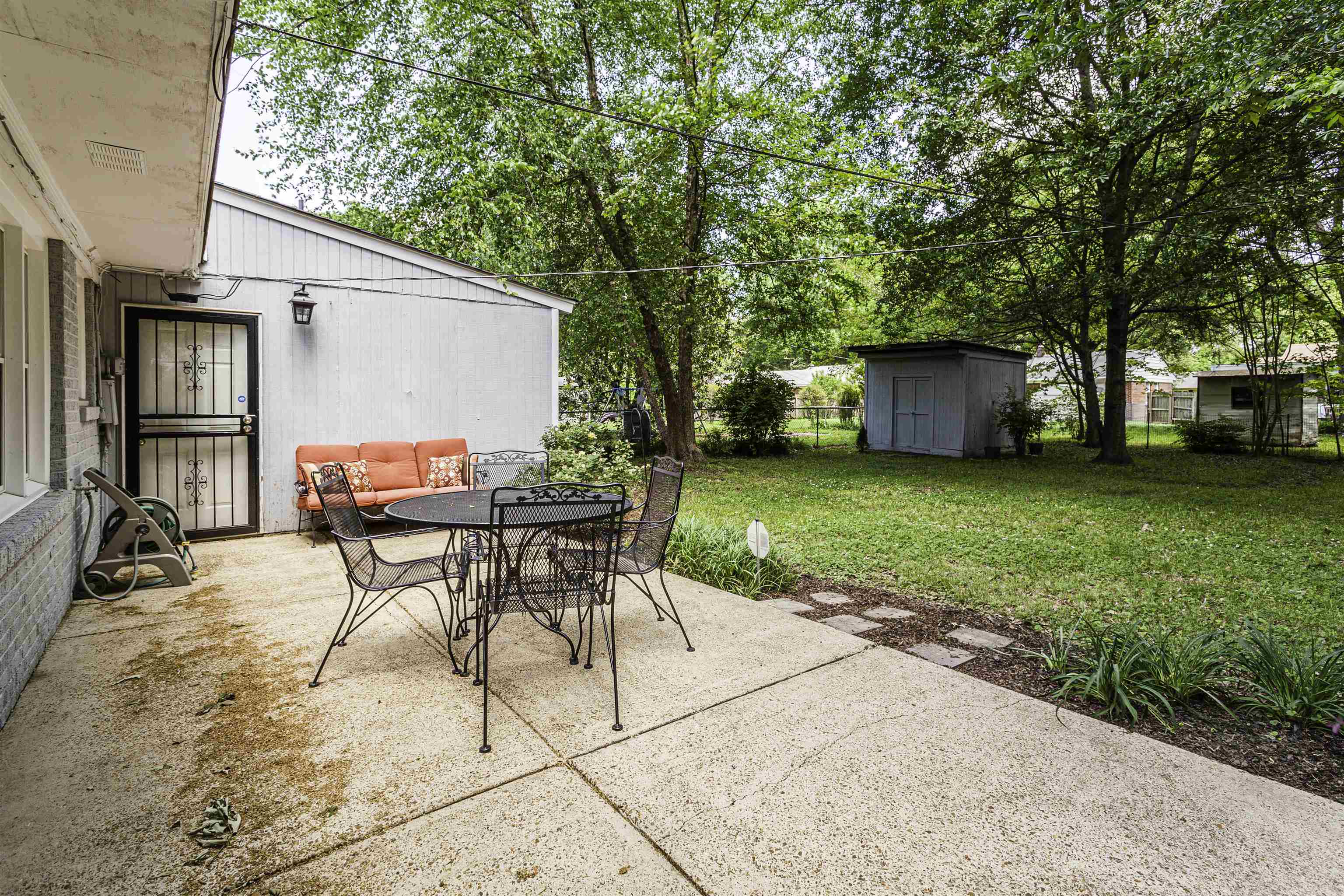 1368 Dearing Road Memphis, TN 38117 - Photo 17 of 19 a view of a backyard with a table and chairs