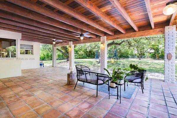 a view of a house with swimming pool and sitting area