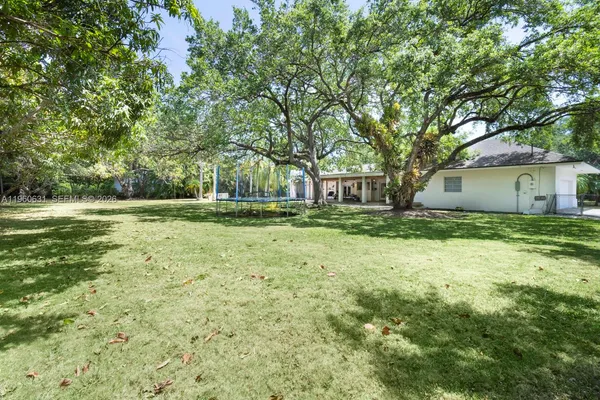 an aerial view of residential house with swimming pool and lawn chairs