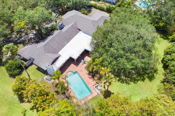 an aerial view of a house with a yard