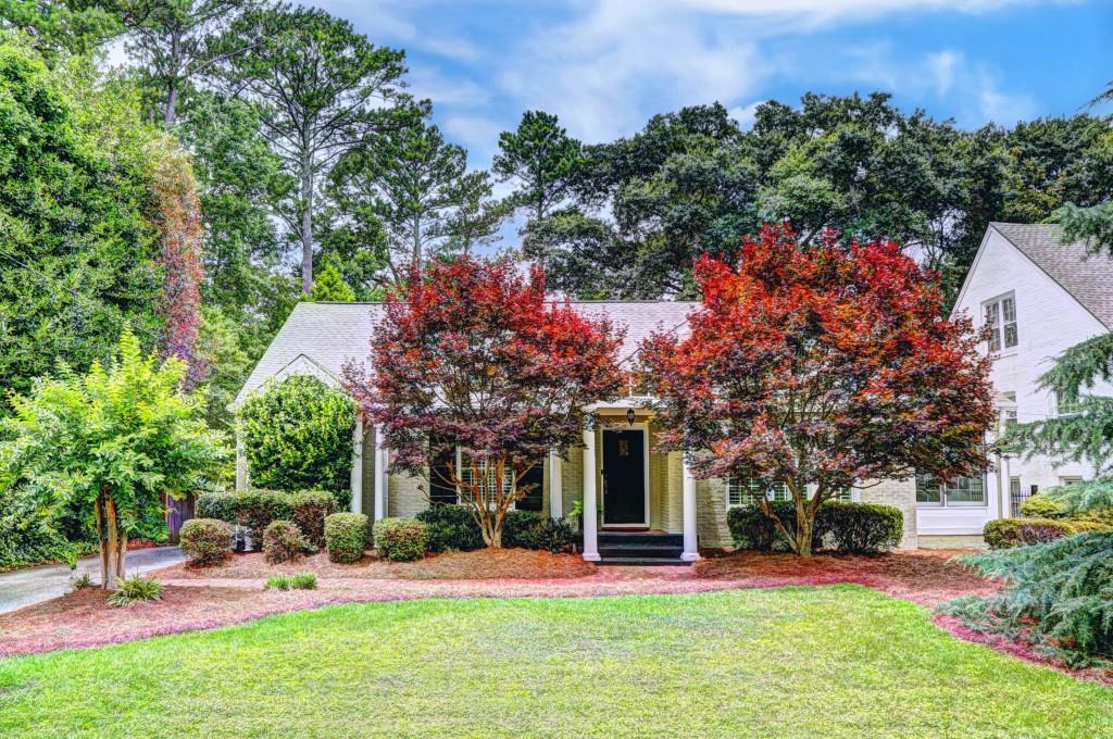 1738 Johnson Road Northeast Atlanta, GA 30306 - Photo 1 of 1 front view of a house with a yard table and chairs
