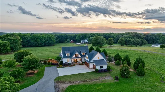 a front view of a house with a garden and plants