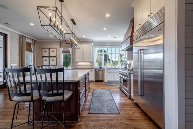 a bedroom with furniture and a large window