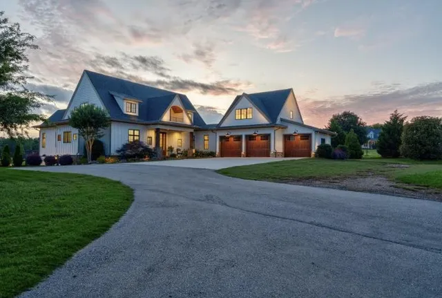 a living room with furniture fireplace and a large window