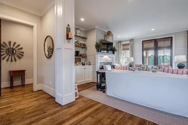 a bedroom with a bed and a flat tv screen on dresser