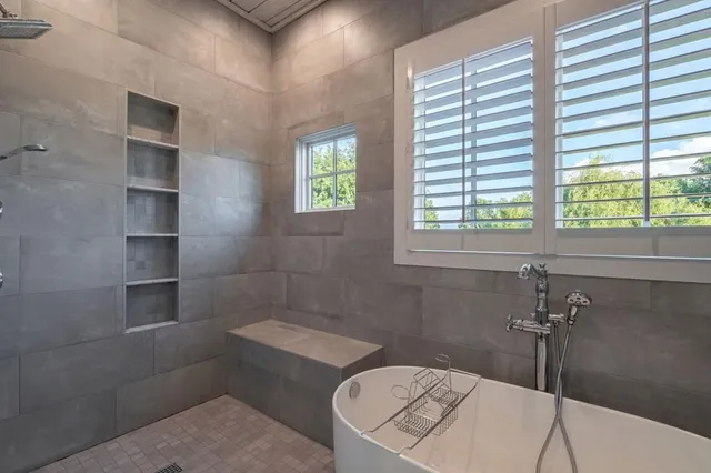 a view of a house with a big yard and large trees