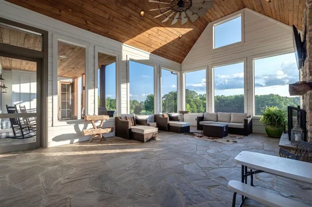 a view of a big house with a big yard and large trees