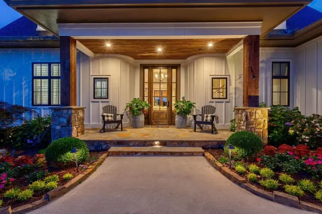 a kitchen with stainless steel appliances granite countertop a sink a stove a refrigerator cabinets and a dining table