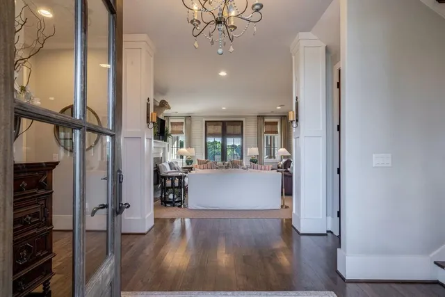 a kitchen with stainless steel appliances kitchen island granite countertop a table chairs in it and wooden floors