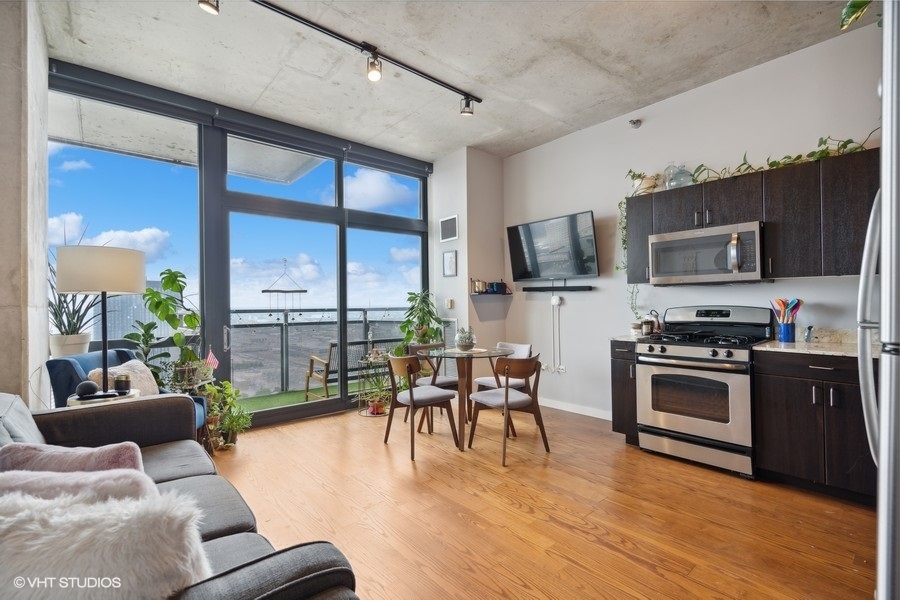 235 West Van Buren Street, Unit 3606 Chicago, IL 60607 - Photo 11 of 27 a living room with stainless steel appliances furniture and a kitchen view