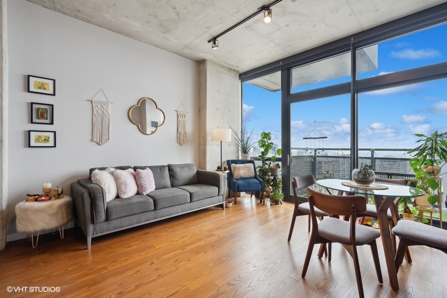 235 West Van Buren Street, Unit 3606 Chicago, IL 60607 - Photo 12 of 27 a living room with furniture kitchen view and a large window