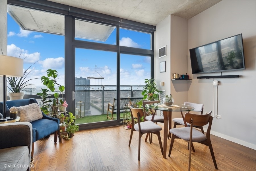 235 West Van Buren Street, Unit 3606 Chicago, IL 60607 - Photo 13 of 27 a dining room with furniture garden view and a flat screen tv