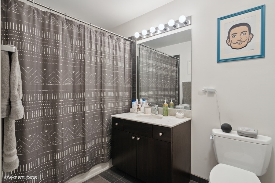 235 West Van Buren Street, Unit 3606 Chicago, IL 60607 - Photo 18 of 27 a bathroom with a sink toilet and shower