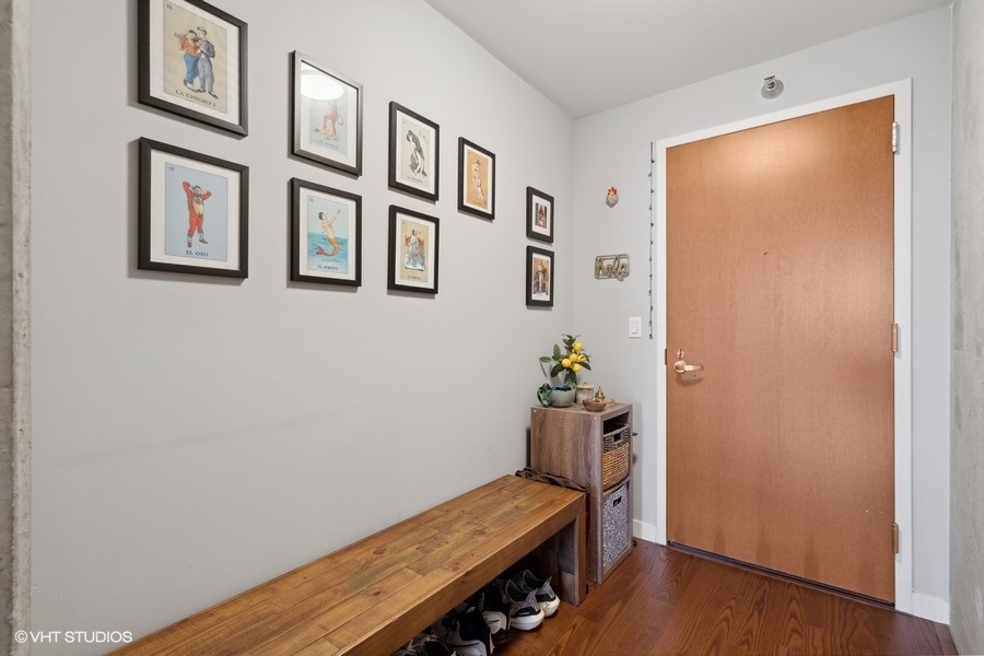 235 West Van Buren Street, Unit 3606 Chicago, IL 60607 - Photo 10 of 27 a room with painting on the wall and a window