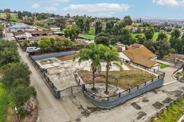 an aerial view of residential houses with outdoor space and river