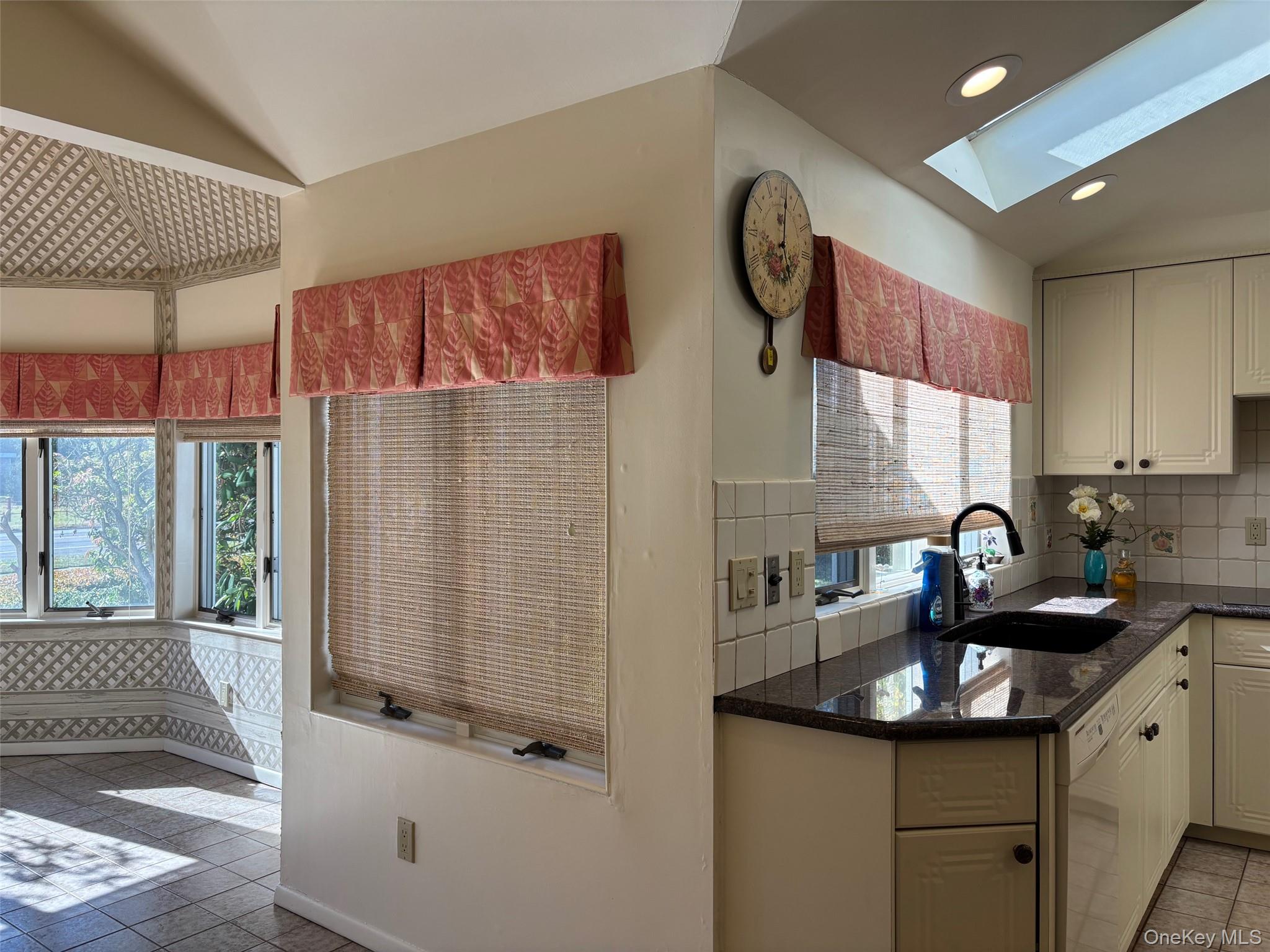 185 South Country Road, Unit S COUNTRY RD East Patchogue, NY 11772 - Photo 13 of 47 Kitchen featuring light tile patterned floors, dark stone counters, decorative backsplash, recessed lighting, and a skylight