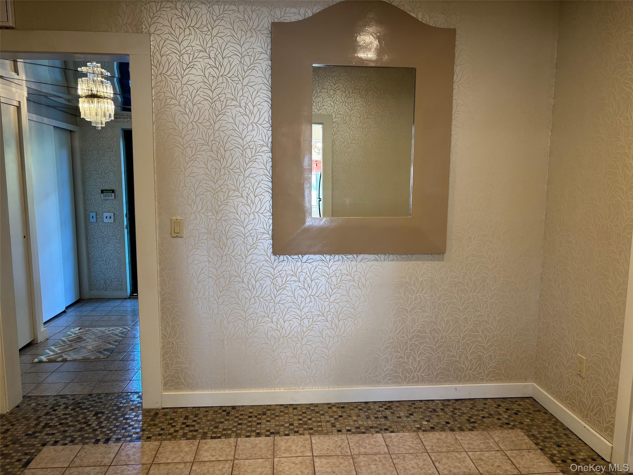 185 South Country Road, Unit S COUNTRY RD East Patchogue, NY 11772 - Photo 20 of 47 Corridor with a chandelier, wallpapered walls, and tile patterned flooring