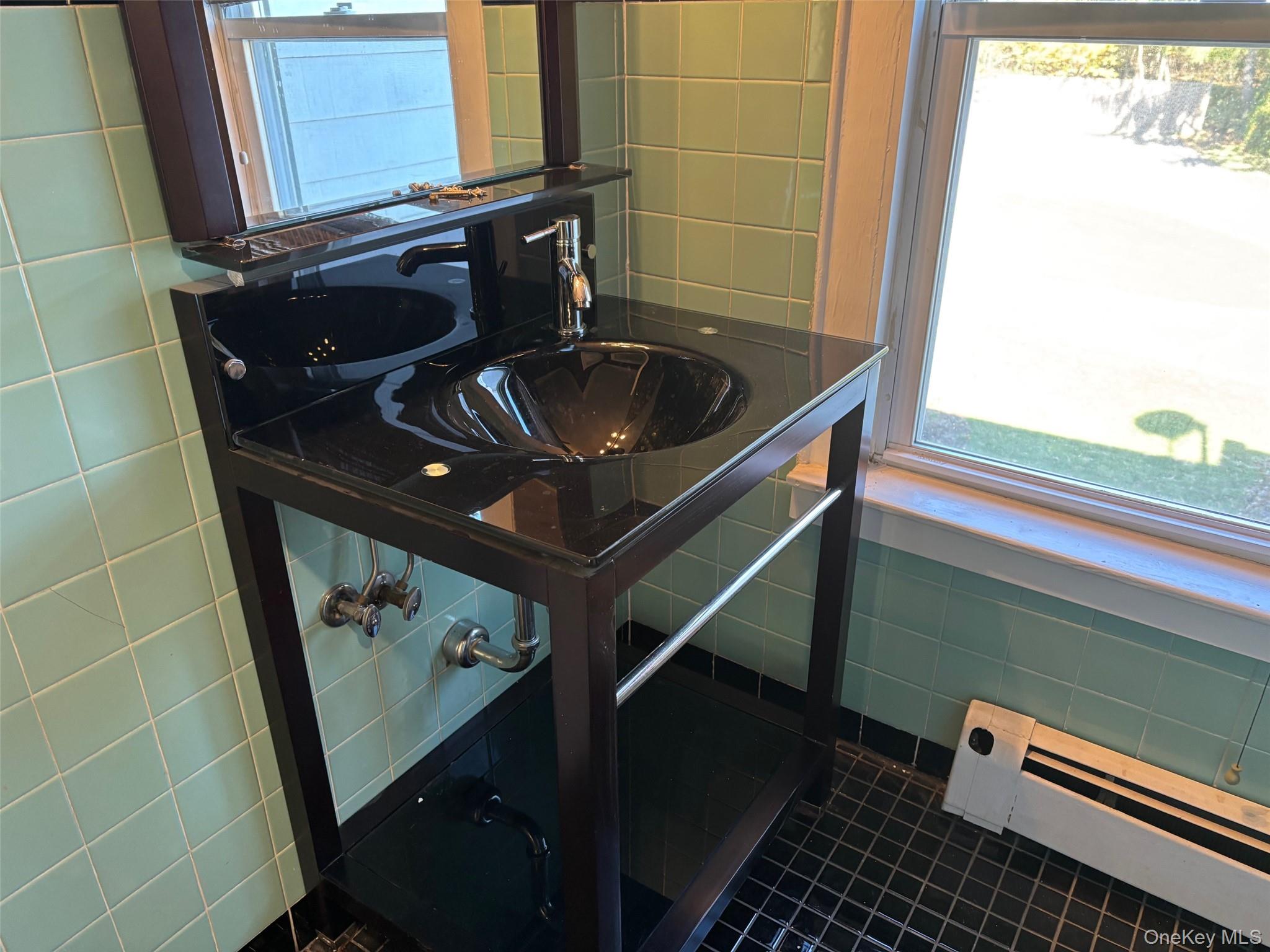 185 South Country Road, Unit S COUNTRY RD East Patchogue, NY 11772 - Photo 26 of 47 Bathroom featuring tile walls, a baseboard heating unit, plenty of natural light, and dark tile patterned floors