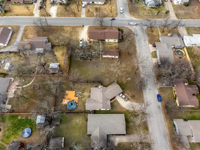 an aerial view of a house with a yard