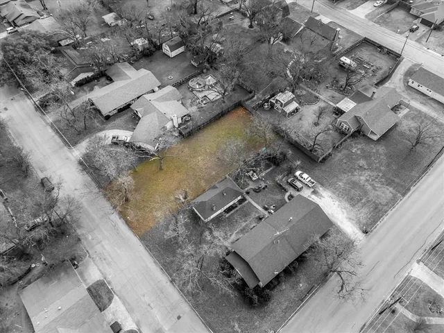 an aerial view of a house with a yard
