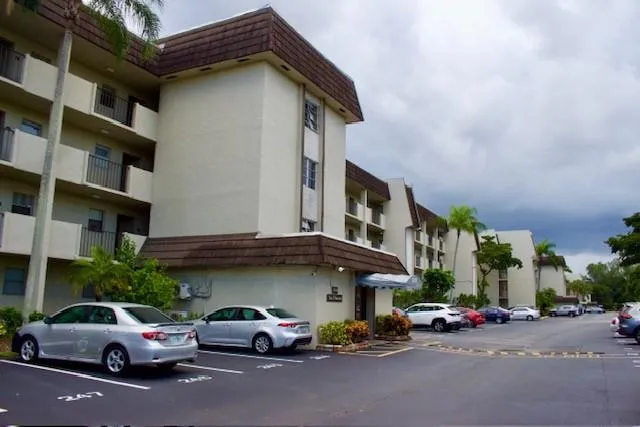 a kitchen with stainless steel appliances a stove top oven a sink a counter top space and cabinets