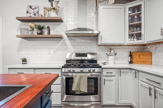 a kitchen with stainless steel appliances granite countertop a stove and a sink