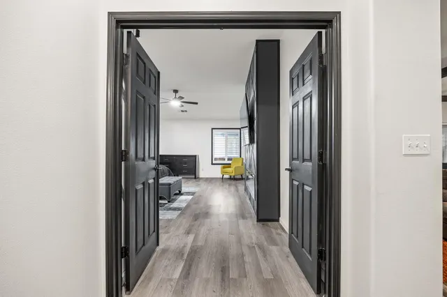 a view of a hallway with wooden floor and staircase