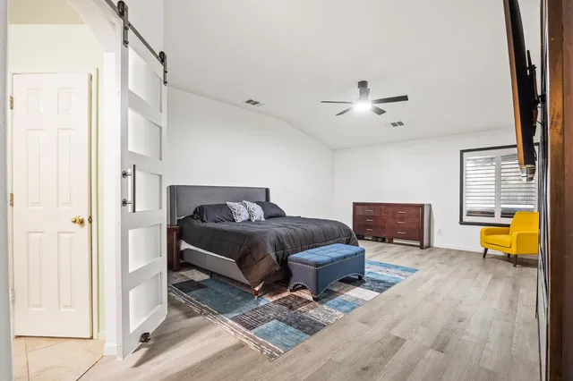 a bedroom with furniture and a chandelier