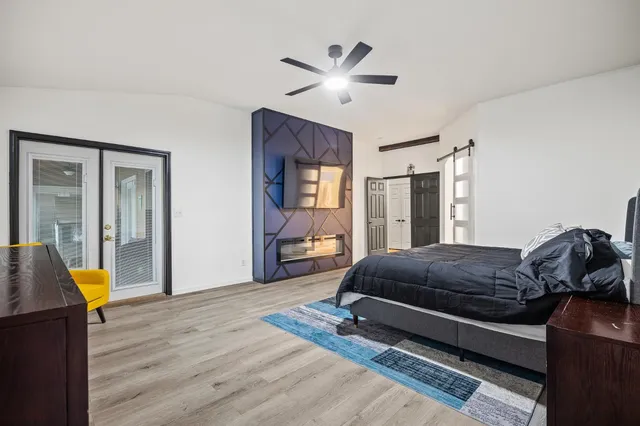 a living room with a bed furniture and windows