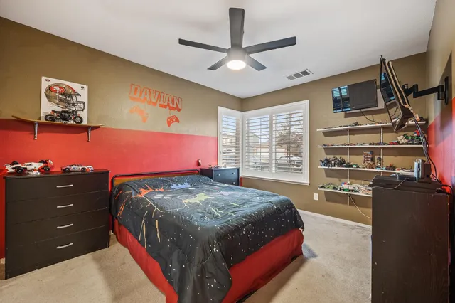 a bedroom with a bed and a television