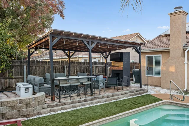 a view of a house with backyard porch and sitting area
