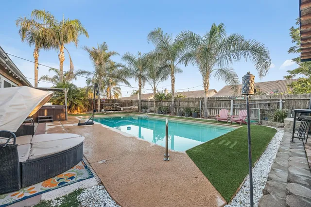 a view of a swimming pool with a patio and a slide