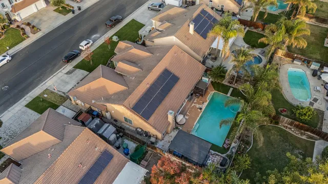 an aerial view of a house with a yard and outdoor seating
