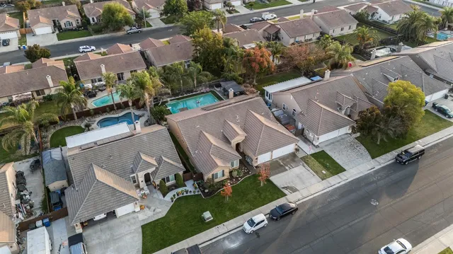 an aerial view of multiple houses with yard