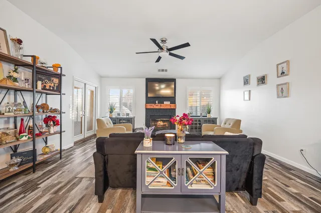 a view of a dining room with furniture wooden floor and chandelier