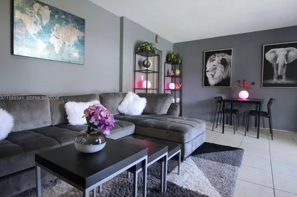 a living room with furniture and painting on the wall