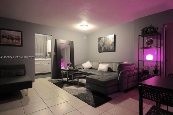 a living room with furniture gym equipment and a lamp